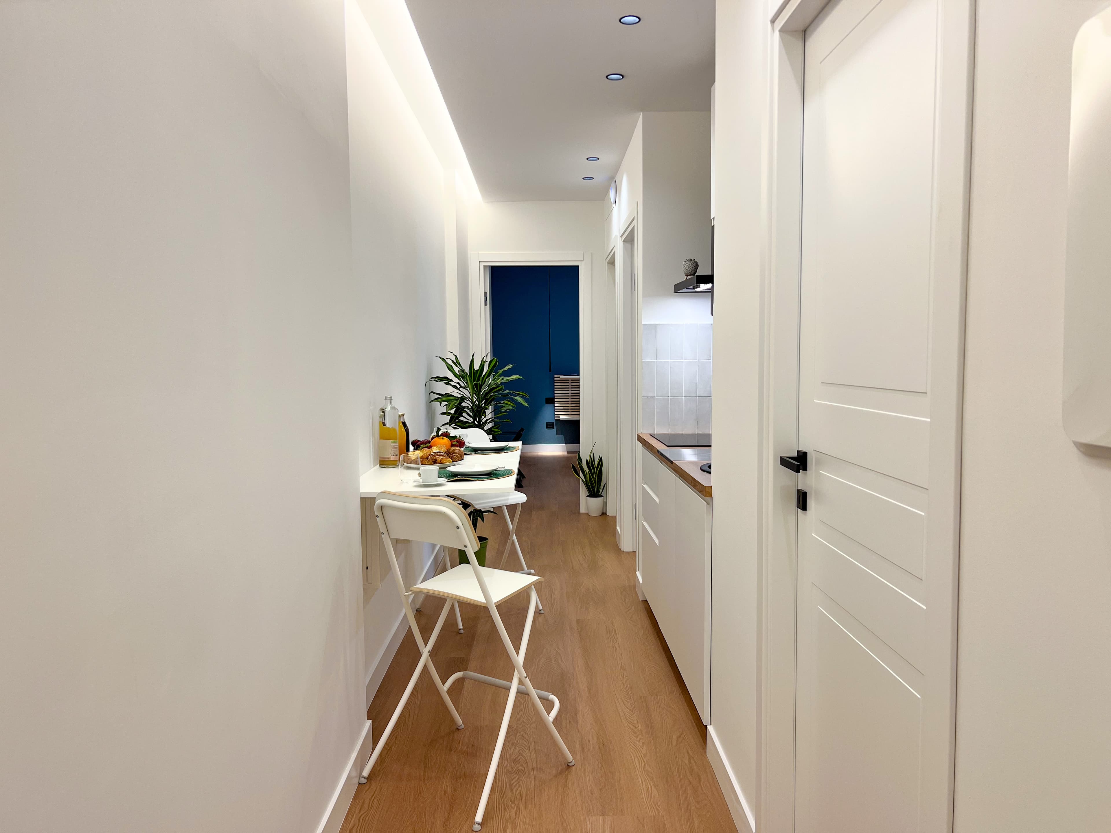 Turquoise apartment hallway and kitchen